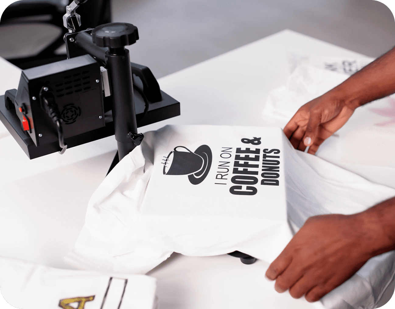 Hands preparing T-shirt with graphic design